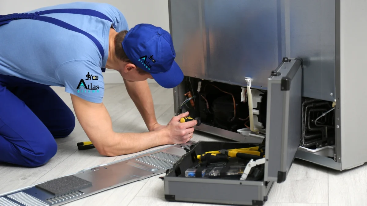 technician inspecting a fridge